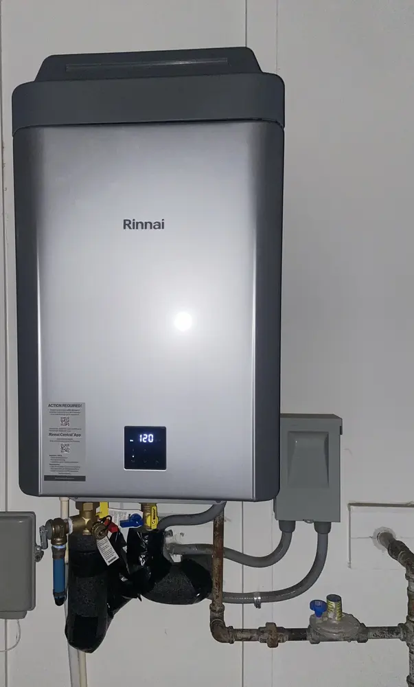 Wall-mounted Rinnai tankless water heater with service valves
